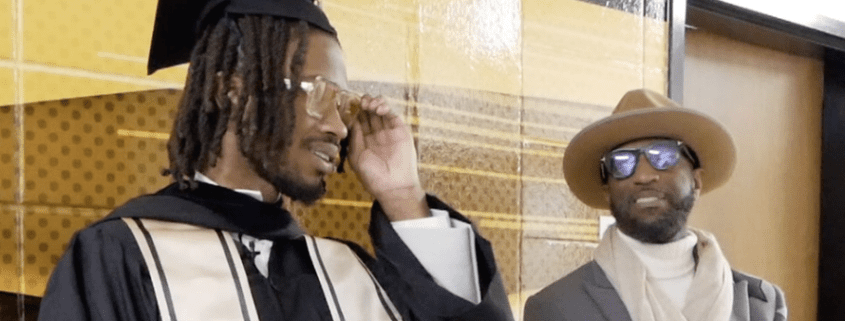 Graduate and man in sunglasses celebrating together.